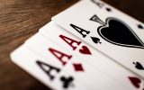 Blackjack table game at McLuck Casino showing cards dealt on a green felt table surface